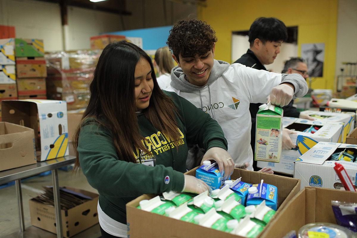 Students packing boxes with food