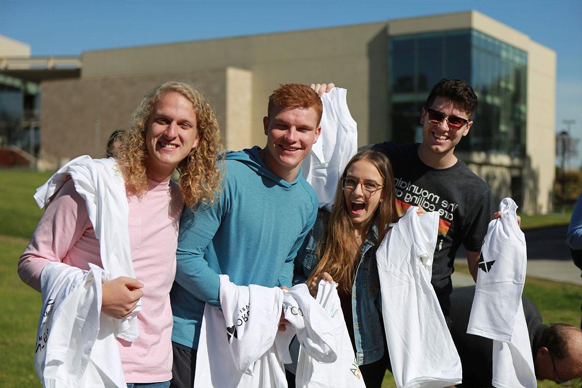 More students posing with their shirts